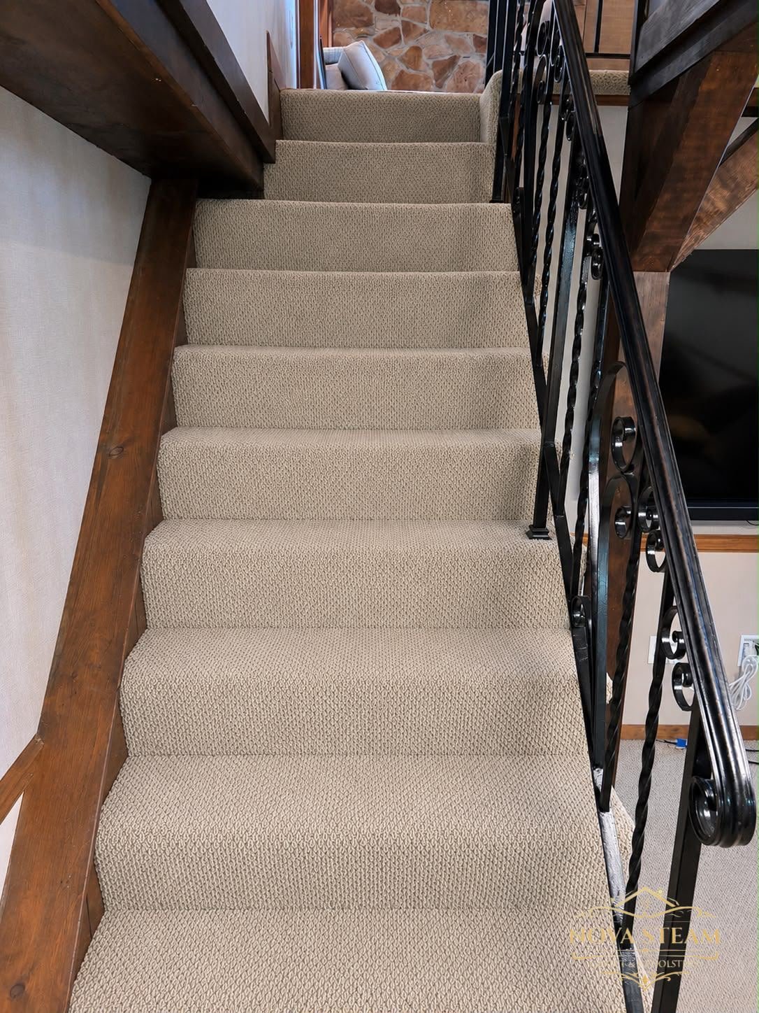 The same staircase after steam extraction, restored to an even, light tan finish